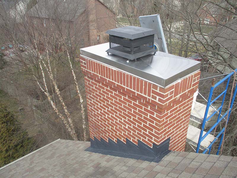 Roofing, Gutters & Siding in Green OH | Roof Gutter Now 21 Newly installed brick chimney with metal cap and chimney damper on residential roofline in Green, OH