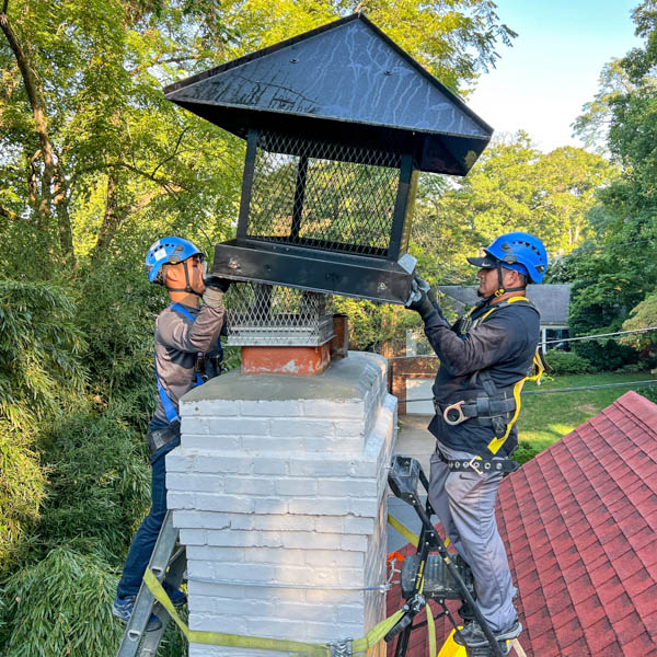 Large chimney cap installation roof crew Northeast Ohio