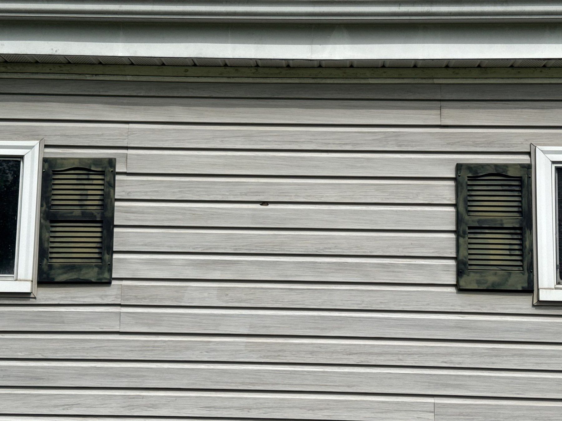 Close up of approved hail damage on garage siding