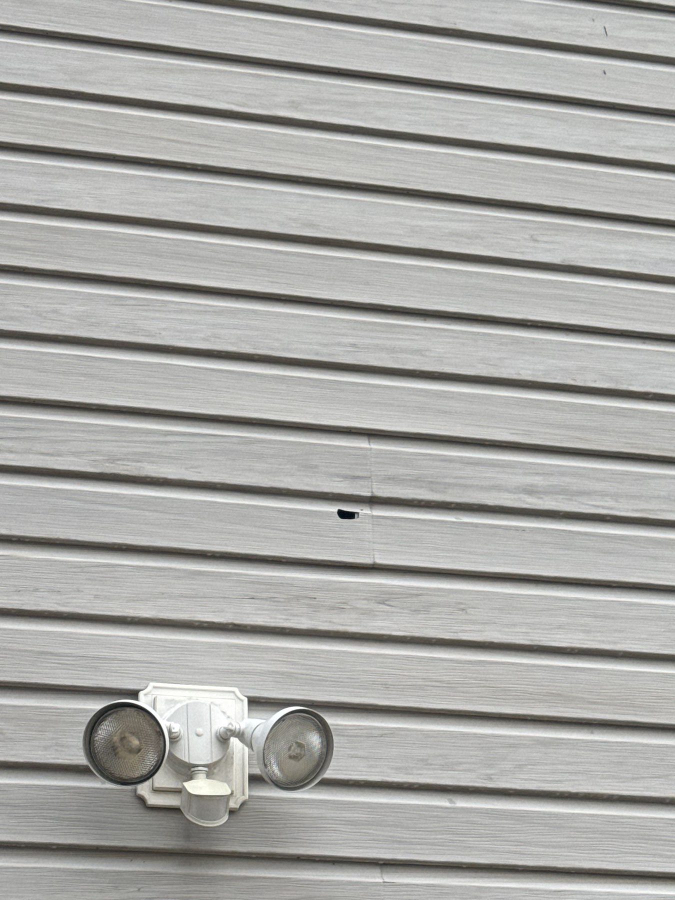 Hail impact damage on house vinyl siding
