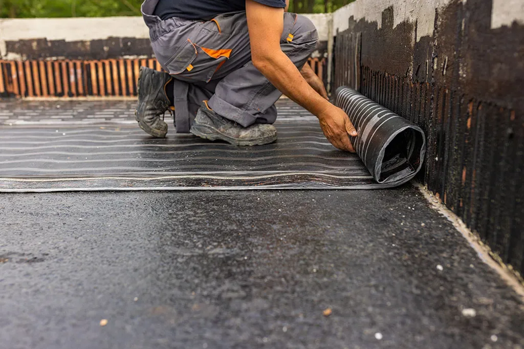 Rubber membrane being installed on flat roof