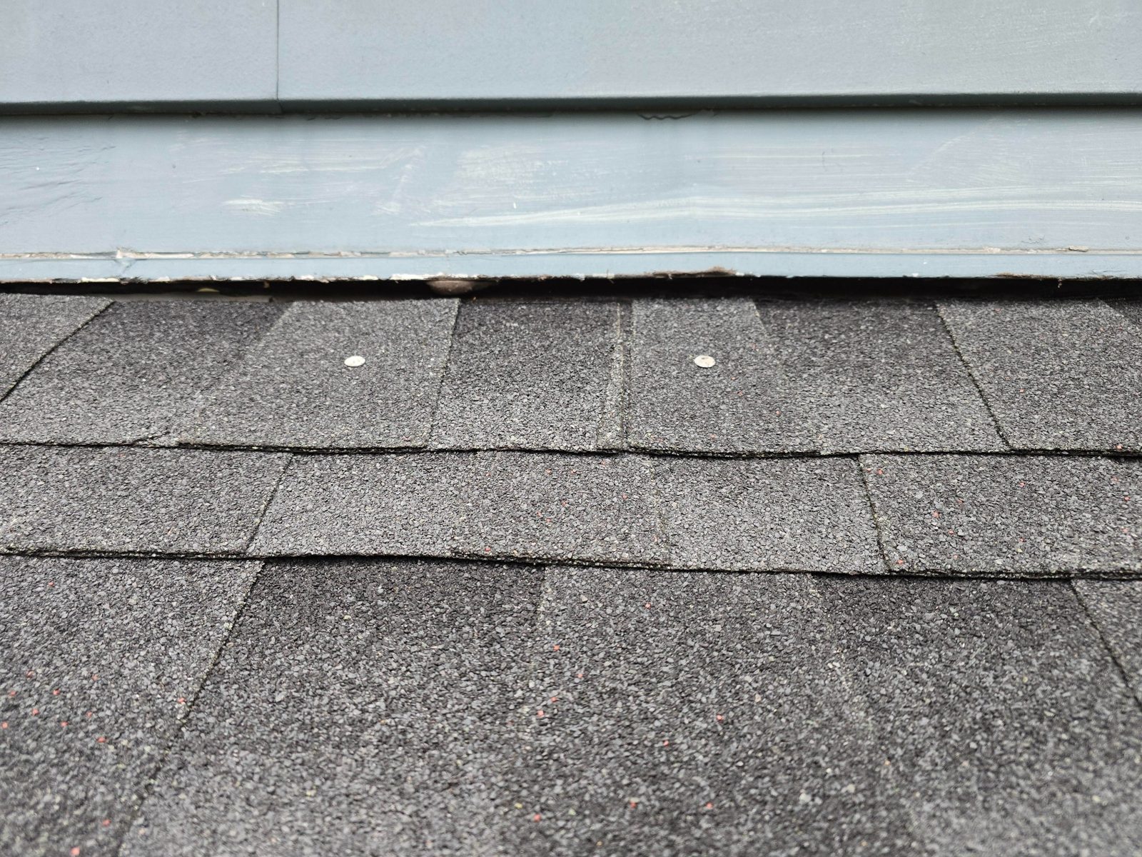 Exposed roof nails awaiting sealing during tune-up