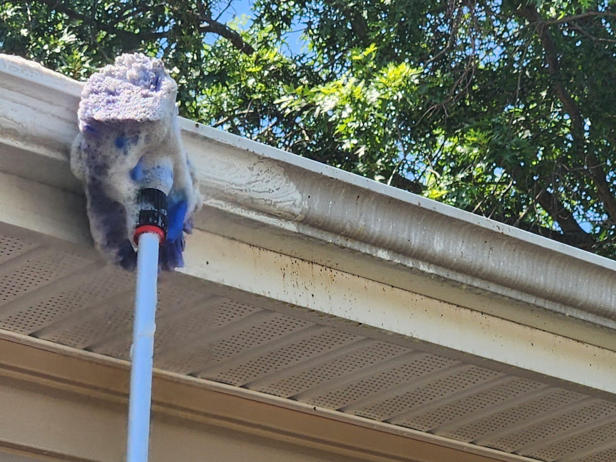 Gutter Brightening | Tiger Stripes Removed | Roof Gutter Now 2 Gutter face being cleaned during brightening