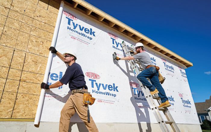 House wrap weather barrier being installed
