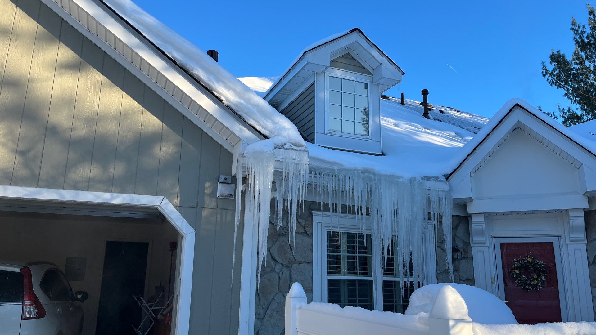 Icicle Removal Services | Roof Gutter Now 2 Icicles indicating ice dam formation above