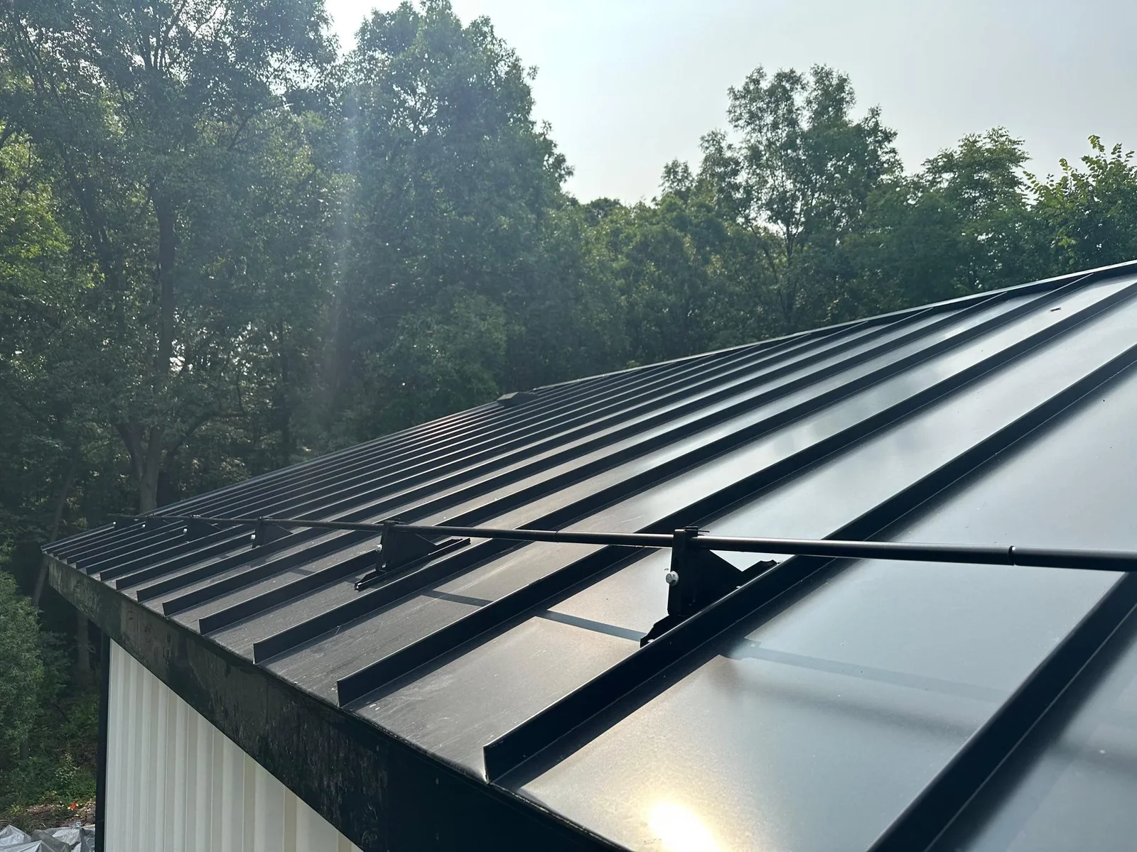 Snow retention rail system on standing seam metal roof