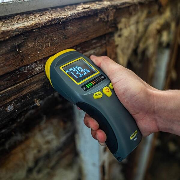 Moisture Inspection | Roof Gutter Now 1 Moisture meter reading a wooden beam