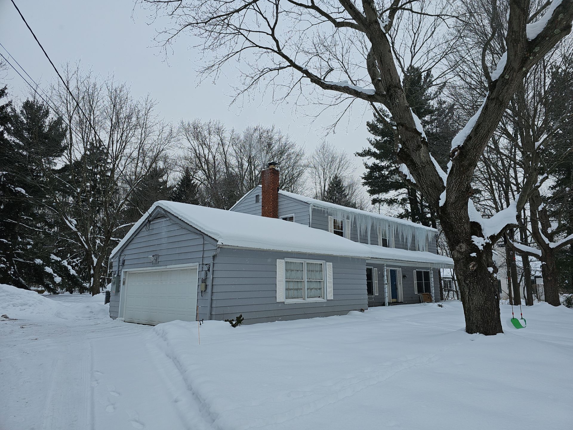 Severe ice dam formation damaging home exterior