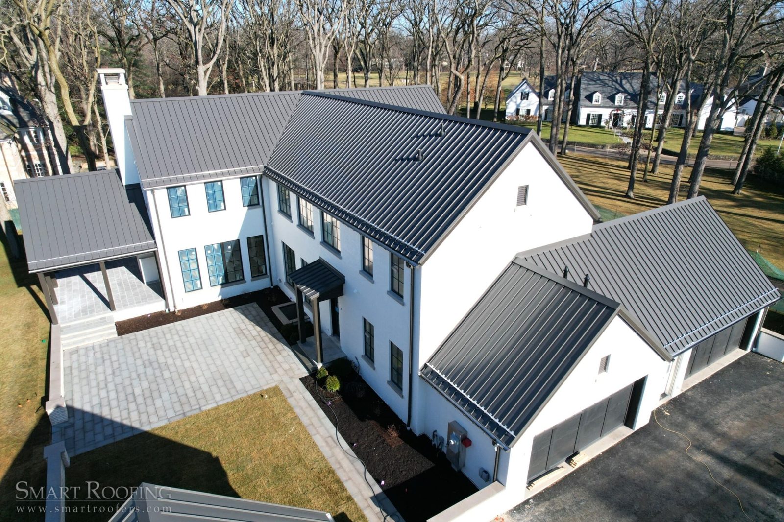 Aerial view of modern home with standing seam metal roof